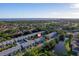 Aerial community shot of waterfront condos with mature landscaping, lakes, and a community pool at 6033 34Th W St # 132, Bradenton, FL 34210