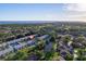 Aerial view of charming townhomes near a scenic pond and lush green landscape at 6033 34Th W St # 132, Bradenton, FL 34210
