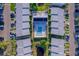 Aerial view of a neighborhood complex with pool, lake, parking, and green lawns at 6033 34Th W St # 132, Bradenton, FL 34210