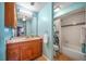 A full bathroom features a single sink with wooden vanity and a shower-tub combo at 6033 34Th W St # 132, Bradenton, FL 34210
