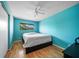 Bright blue bedroom with wood floors, ceiling fan, and a window providing natural light at 6033 34Th W St # 132, Bradenton, FL 34210