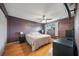 Comfortable bedroom with a ceiling fan, window, and wood floor; furnished with bedside table and dresser at 6033 34Th W St # 132, Bradenton, FL 34210