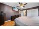 Bedroom featuring a ceiling fan, wall-mounted TV, hardwood floor, and closet at 6033 34Th W St # 132, Bradenton, FL 34210