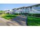 Well-maintained condo complex with assigned parking spaces, green lawns, and landscaped bushes at 6033 34Th W St # 132, Bradenton, FL 34210