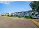 Exterior shot of light blue condos with manicured lawns, white stairways and assigned parking at 6033 34Th W St # 132, Bradenton, FL 34210