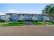 Well-maintained condo complex with assigned parking spaces, green lawns, and landscaped bushes at 6033 34Th W St # 132, Bradenton, FL 34210