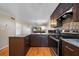 Cozy kitchen view showing wood cabinetry, stainless steel appliances, and marble countertops at 6033 34Th W St # 132, Bradenton, FL 34210