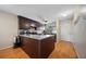 Kitchen with granite countertops, stainless steel appliances, dark cabinets and wooden floors at 6033 34Th W St # 132, Bradenton, FL 34210