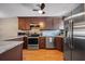 Well-lit kitchen featuring stainless steel appliances, wood cabinetry, and stylish countertops at 6033 34Th W St # 132, Bradenton, FL 34210
