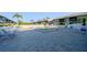 Community pool with lounge chairs surrounded by lush tropical landscaping near condo residences at 6033 34Th W St # 132, Bradenton, FL 34210