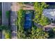 Overhead shot of blue tennis court surrounded by verdant trees and lush landscaping at 6033 34Th W St # 132, Bradenton, FL 34210