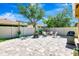 Paver patio with grill, dining set, and fire pit, all set against a fenced backyard at 6729 45Th E Ter, Bradenton, FL 34203