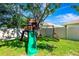 A fun, green backyard with slide, swing set and tree house at 6729 45Th E Ter, Bradenton, FL 34203