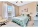 Bedroom with a comfortable bed, large window, and neutral decor at 6729 45Th E Ter, Bradenton, FL 34203