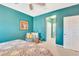 Bright bedroom featuring stylish decor, a seating area, and an ensuite bathroom at 6729 45Th E Ter, Bradenton, FL 34203
