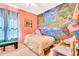 Cozy bedroom with a colorful mural, comfortable bed, and decorative accents at 6729 45Th E Ter, Bradenton, FL 34203
