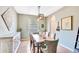 Dining area featuring a wooden table, decorated chairs, and elegant lighting in a stylish setting at 6729 45Th E Ter, Bradenton, FL 34203