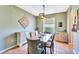 Dining area with a wooden table, upholstered chairs, decorative lighting, and neutral wall colors at 6729 45Th E Ter, Bradenton, FL 34203