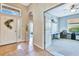 Inviting foyer with tile flooring, decorative front door with sidelight, arched doorway, and bright office space at 6729 45Th E Ter, Bradenton, FL 34203