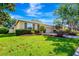 Beautiful home featuring lush green lawn, manicured bushes, and mature trees creating a serene curb appeal at 6729 45Th E Ter, Bradenton, FL 34203