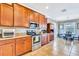 Well-lit kitchen featuring wooden cabinetry, granite counters, and stainless steel appliances at 6729 45Th E Ter, Bradenton, FL 34203