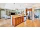 Open kitchen with stainless steel appliances, granite countertops, and seamless flow into the living area at 6729 45Th E Ter, Bradenton, FL 34203