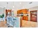 Kitchen view featuring an island with bar stool seating, granite countertops, and stainless steel appliances at 6729 45Th E Ter, Bradenton, FL 34203