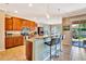 Modern kitchen with granite countertops, wooden cabinetry, breakfast bar, and stainless steel appliances at 6729 45Th E Ter, Bradenton, FL 34203