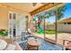 Screened lanai with a hanging chair and view of the play area in the backyard at 6729 45Th E Ter, Bradenton, FL 34203