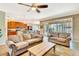 Open-concept living room showcasing comfortable sofas, a coffee table, and seamless flow to the kitchen and patio at 6729 45Th E Ter, Bradenton, FL 34203