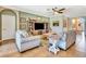 Spacious living room featuring comfortable seating, neutral tones, and an archway leading to other living spaces at 6729 45Th E Ter, Bradenton, FL 34203