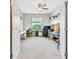 Well-lit office space featuring neutral carpeting, white walls, and shelving, perfect for working from home at 6729 45Th E Ter, Bradenton, FL 34203