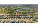 Aerial view of a community featuring residential homes, water features, and golf course views at 6936 White Willow Ct, Sarasota, FL 34243