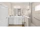 Bathroom featuring double sinks, modern fixtures, and a glass-enclosed shower at 6936 White Willow Ct, Sarasota, FL 34243