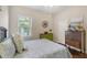Cozy bedroom with wood floors, bright accents, and a large window at 6936 White Willow Ct, Sarasota, FL 34243