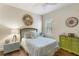 Well-lit bedroom with wood floors, coastal decor, and a sunny window at 6936 White Willow Ct, Sarasota, FL 34243