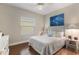Bright bedroom with hardwood floors, a queen-sized bed and nautical themed decor at 6936 White Willow Ct, Sarasota, FL 34243