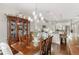Elegant dining room with a china cabinet, chandelier, and plenty of natural light at 6936 White Willow Ct, Sarasota, FL 34243