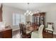 Cozy dining room featuring a traditional dining set and ample natural light at 6936 White Willow Ct, Sarasota, FL 34243