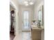 Inviting entryway with tile flooring, decorative mirror, and stylish accents creating a warm welcome at 6936 White Willow Ct, Sarasota, FL 34243