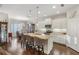 Modern kitchen with stainless steel appliances, white cabinetry, granite countertops, and an eat-in island at 6936 White Willow Ct, Sarasota, FL 34243