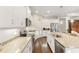 Bright kitchen with white cabinetry, stainless steel appliances, and granite countertops at 6936 White Willow Ct, Sarasota, FL 34243