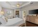 Bright main bedroom featuring a ceiling fan, wood floors, and natural light at 6936 White Willow Ct, Sarasota, FL 34243