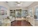 Cozy office with hardwood floors, custom built-in shelving, and ample natural light for a productive workspace at 6936 White Willow Ct, Sarasota, FL 34243