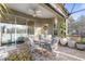 Screened patio with dining set, ceiling fan, and views of the backyard at 6936 White Willow Ct, Sarasota, FL 34243