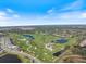 Panoramic aerial view highlighting the community's expansive golf course, lakes, and residential areas at 72 Grande Fairway, Englewood, FL 34223