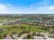 Community aerial view showcasing 72 Grande Fairway's location on a lush golf course and scenic lake at 72 Grande Fairway, Englewood, FL 34223