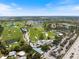 Wide aerial shot of a sprawling community with golf courses, lakes, and homes extending towards the horizon at 72 Grande Fairway, Englewood, FL 34223