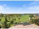 Expansive aerial view of a pristine golf course community with mature trees and scenic water features at 72 Grande Fairway, Englewood, FL 34223