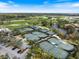 Stunning aerial view of the community's tennis courts and surrounding lush landscape at 72 Grande Fairway, Englewood, FL 34223